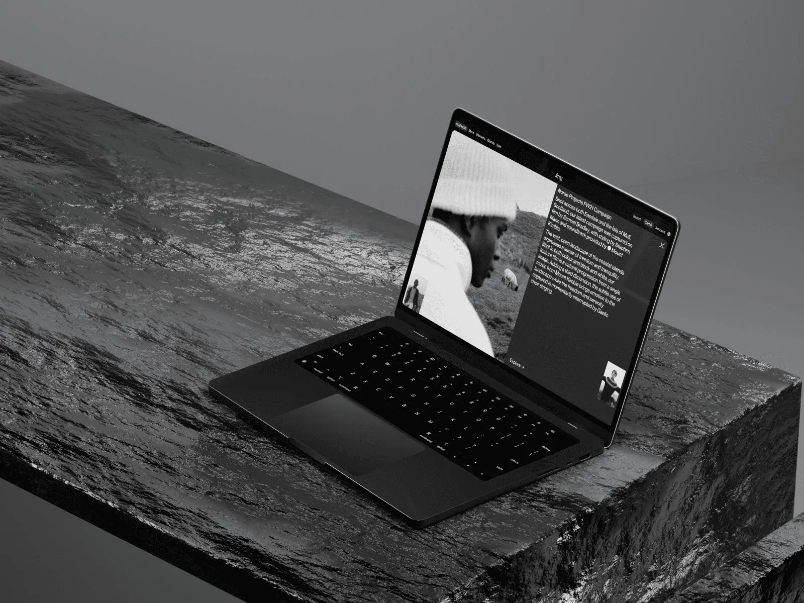 Laptop with a customer story page on a dark rock